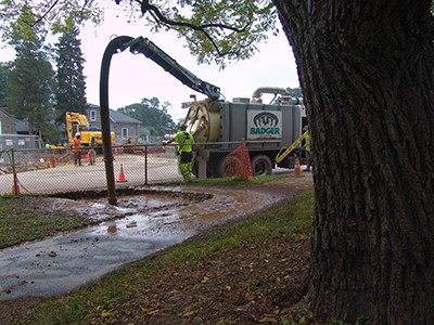 Here you can see hydrovac excavation uses pressurized water to break up the soil cover.  photo credit: R. Robert